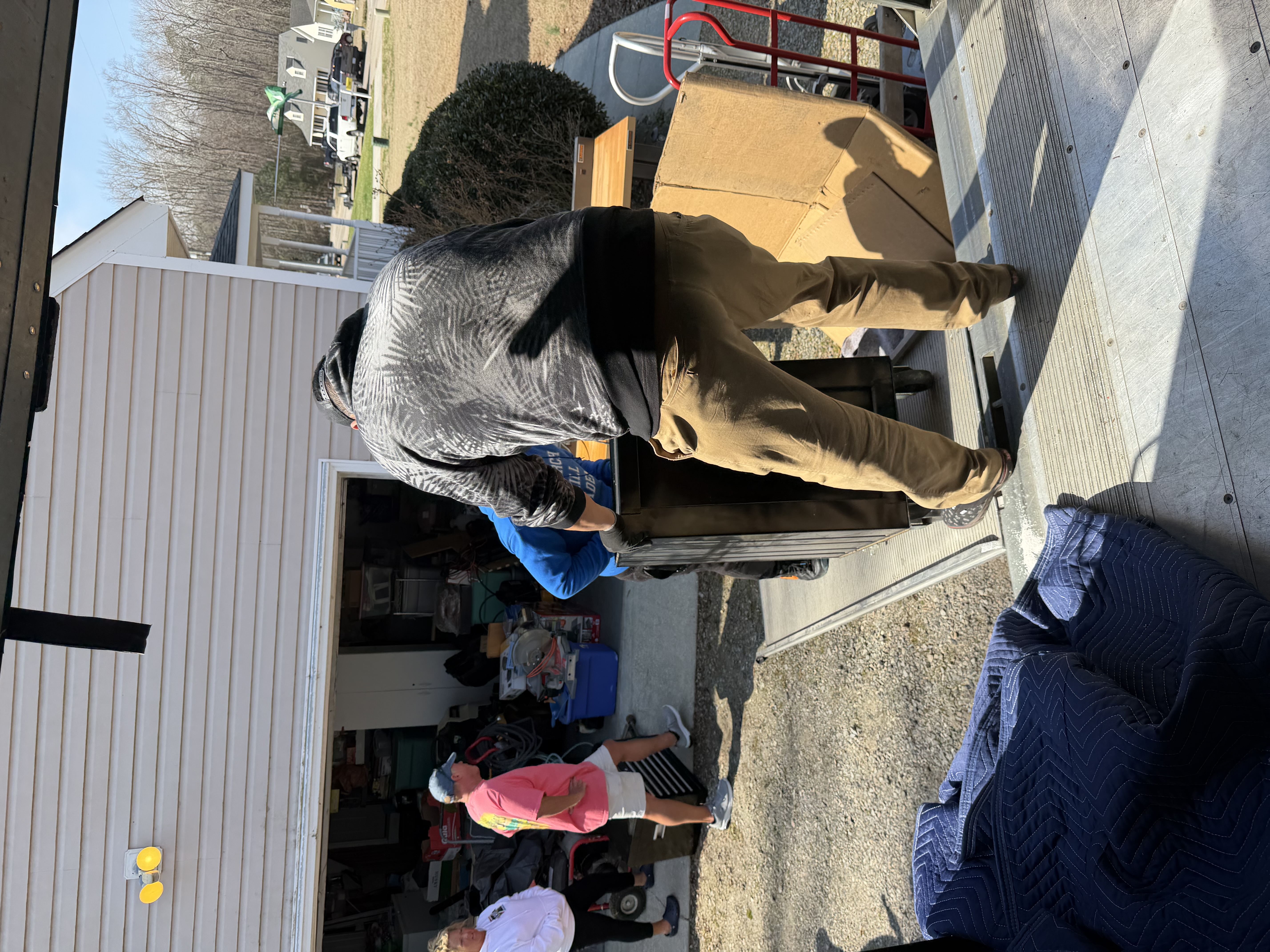RVA Movers crew loading furniture from a Richmond home onto a moving truck ramp